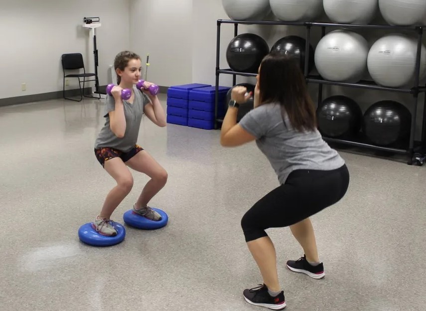 Jen doing weights with a physical therapy patient